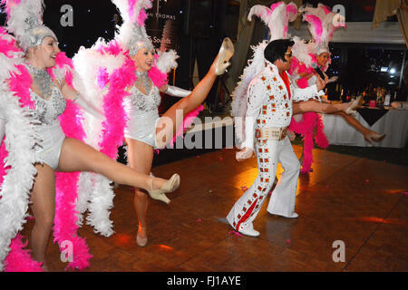 Elvis Tribute singer Mick de bonne volonté avec des danseuses à un organisme de bienfaisance nuit de Hinckley, UK. Banque D'Images