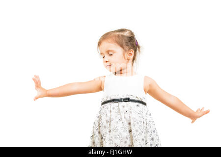 Cute little girl dancing with closed eyes isolated Banque D'Images