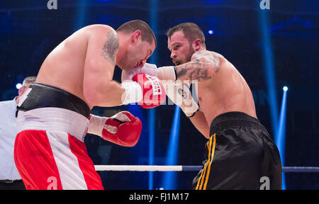 Halle, Allemagne. Feb 27, 2016. Dominik Britsch (R, Allemagne) et Ilaria Simeunovic (Bosnie-Herzégovine) lutte pendant la match de boxe des poids moyens à l'IBO Championnats du monde à Halle, Allemagne, 27 février 2016. Photo : GUIDO KIRCHNER/dpa/Alamy Live News Banque D'Images