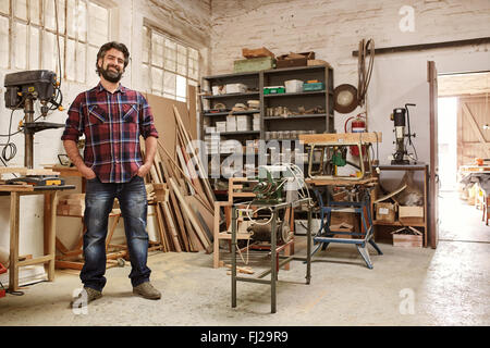 Artisan dans son atelier avec des machines de menuiserie Banque D'Images