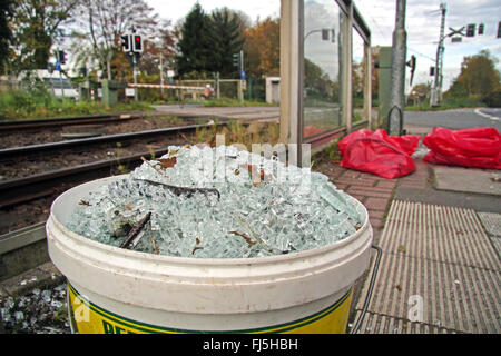 Seau avec des tessons de verre, bris causés par le vandalisme dans une gare, Allemagne Banque D'Images