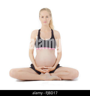 Exercice de forme physique de la femme enceinte. Sitting Holding Belly Banque D'Images