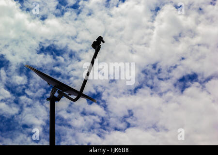 Une photo d'une antenne satellite sur fond de ciel bleu Banque D'Images