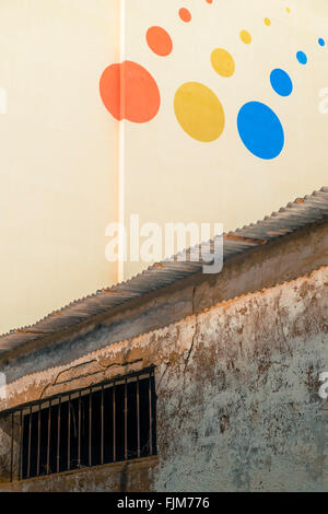 Rouge, jaune et des points bleus de différentes tailles sur le mur Banque D'Images