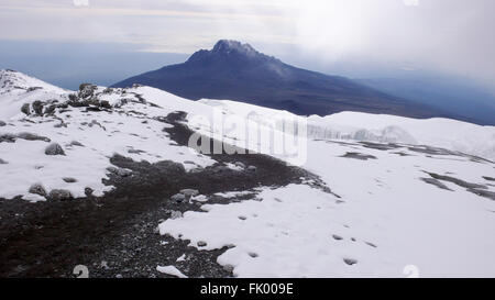 Le sentier de Stella Point à Uhuru Peak au sommet du mont Kilimandjaro, le Mont Meru et dans l'arrière-plan. Banque D'Images