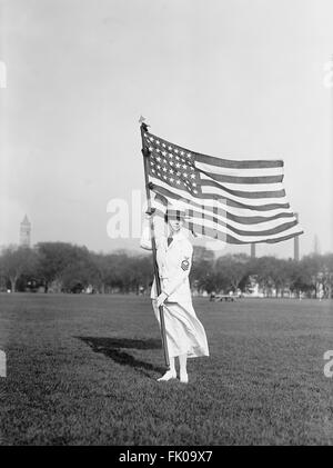 Marine Femme Yeoman en blanc de l'uniforme d'été Holding drapeau américain, USA, vers 1917 Banque D'Images