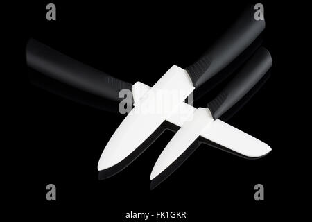 Set de 3 couteaux céramique blanche sur fond noir reflétant Banque D'Images