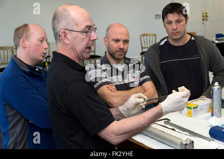 Les hommes adultes enseignés l'ingénierie et la pneumatique par ingénieur diplômé de l'instructeur. Banque D'Images