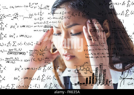 Image composite de nervous businesswoman holding sa tête Banque D'Images