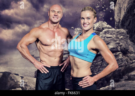 Image composite de portrait of man and woman with hand on hip Banque D'Images