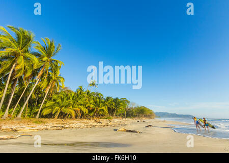 Surfers sur Playa Santa Teresa, une plage de surf sud près de Mal Pais, Péninsule de Nicoya, Santa Teresa, Puntarenas, Costa Rica Banque D'Images