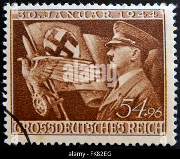 Allemagne - circa 1944 : un timbre-poste imprimé en l'Allemagne montre Adolf Hitler et symboles de Troisième Reich, circa 1944 Banque D'Images