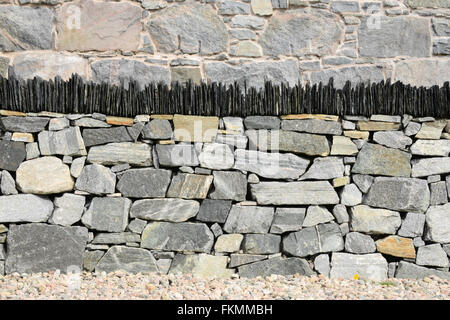 Un nouveau mur de pierre sèche immaculée surmontée d'ardoises verticales sur l'île de Harris, Hébrides extérieures, en Écosse Banque D'Images