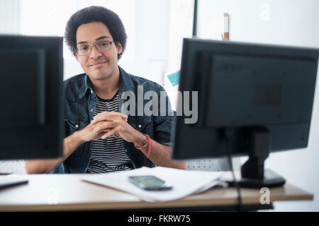 Mixed Race woman smiling in office Banque D'Images