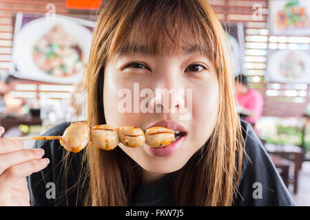 Asia girl eating meat balls Banque D'Images