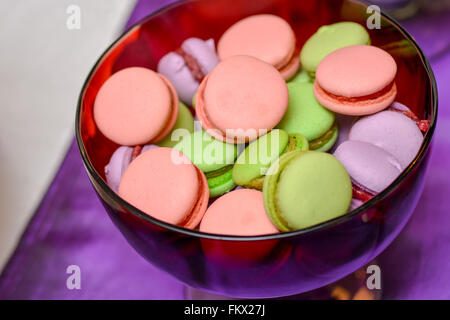 Rose, vert et violet macarons sur une plaque de verre Banque D'Images