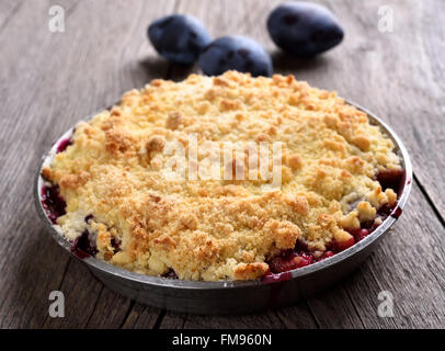 Plum crumb pie dans le moule, sur fond de bois Banque D'Images