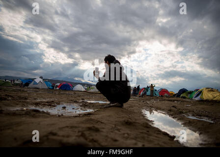 Idomeni, Grèce. Mar 11, 2016. Une république à parler au téléphone dans le camp de réfugiés en Idomeni, Grèce, 11 mars 2016. Depuis la frontière a été fermée, 12 500 réfugiés vivent dans le camp. Photo : Kay Nietfeld/dpa/Alamy Live News Banque D'Images