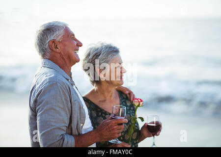 Senior couple holding rose et verres à vin rouge Banque D'Images