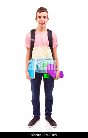Portrait of a school boy holding a skateboard et naturelle, isolated on white Banque D'Images