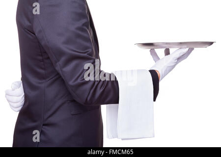 Waiter holding a silver tray vide, isolé sur fond blanc Banque D'Images