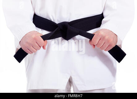 Arts martiaux l'homme attachant sa ceinture noire, isolated on white Banque D'Images