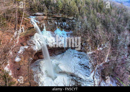 L'eau de la partie supérieure de Kaaterskill Falls dans une piscine au milieu de la glace dans les Catskills Mountains of New York. Banque D'Images