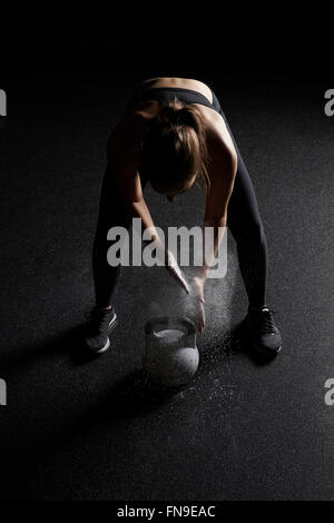 Femme préparez à soulever électrique bell in a gym Banque D'Images