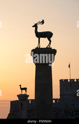 La ville de Rhodes, Rhodes, Grèce, sud de la Mer Egée. Des statues de cerfs à l'entrée du port de Mandraki, le lever du soleil. Banque D'Images