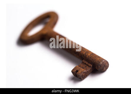 Old rusty key isolé sur fond blanc avec une faible profondeur de champ Banque D'Images