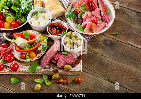 Apéritif set. Viande, légumes et fromage sur planche de bois. Vue d'en haut Banque D'Images
