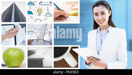 Composite image of smiling businesswoman writing on notepad Banque D'Images