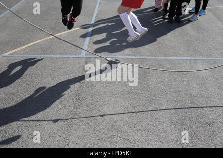 Les élèves sauts pendant les périodes de jeu au Red Hall Junior School à Darlington, comté de Durham, Royaume-Uni. Banque D'Images