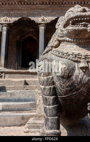 Le Népal, Patan, Durbar Square. Tigres mythique garde Entrée de la Krishna Mandir. Banque D'Images