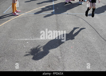 Les élèves sauts pendant les périodes de jeu au Red Hall Junior School à Darlington, comté de Durham, Royaume-Uni. Banque D'Images