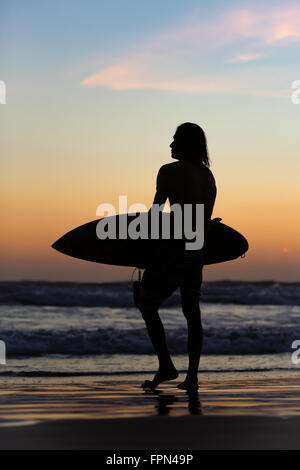 Silhouette d'un surfer en regardant le coucher du soleil, de la plage de Sanur, Bali, Indonésie, Asie Banque D'Images