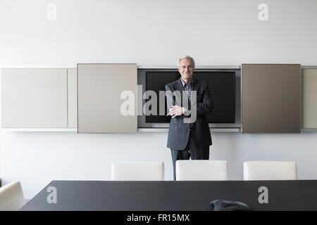 Portrait confiant senior businessman in conference room Banque D'Images