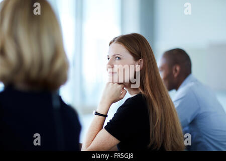 Confident businesswoman listening in meeting Banque D'Images