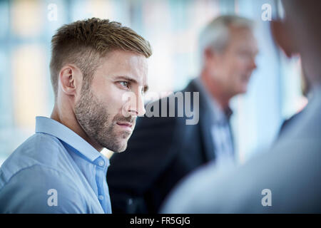 Serious businessman listening in meeting Banque D'Images