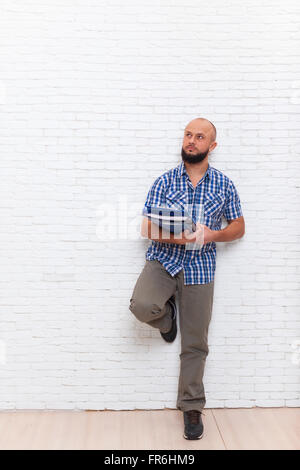 Barbu occasionnels sérieux Business Man Holding Folder regarder vers copie Espace méditer douteux Banque D'Images