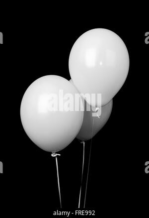Trois ballons blanc isolé sur fond noir Banque D'Images