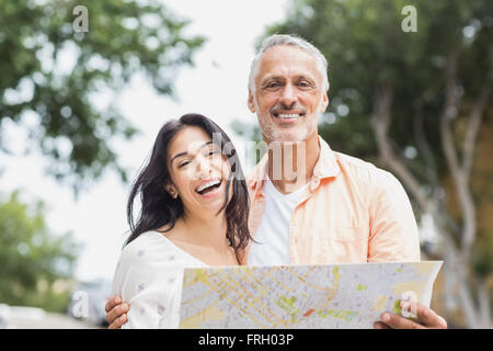 Couple holding la carte en ville Banque D'Images