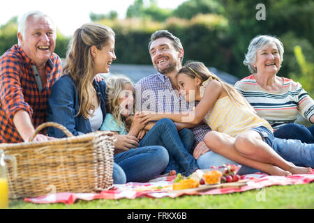 Happy family sitting on blanket Banque D'Images