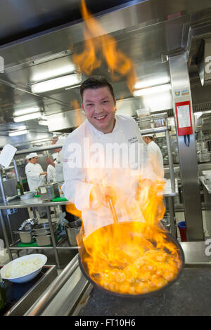 Chef exécutif de l'Erik Brack bateau de croisière MS Deutschland, Peter Deilmann Reederei, flambeing les langoustines dans le bloc-cuisine, Mer de Chine du Sud, près de Taiwan Banque D'Images