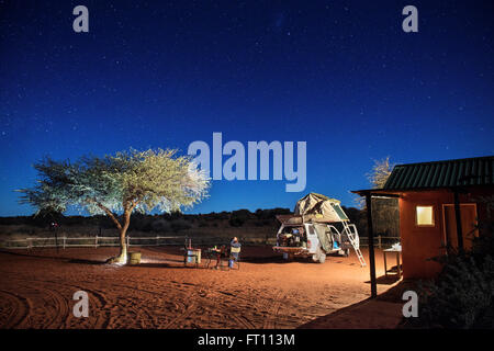 Feu de camp sous les étoiles dans le desert camp dans le désert de Kalahari, 4x4 tente sur le toit, la Namibie, l'Afrique Banque D'Images