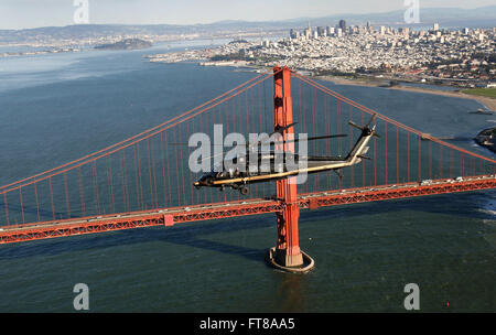 Un hélicoptère Black Hawk des douanes et de la protection des frontières des États-Unis survole le Golden Gate Bridge de San Francisco avec l'horizon de la ville visible en arrière-plan. Cette photo a été prise le 1er février 2016, lors des opérations du Super Bowl 50. Banque D'Images