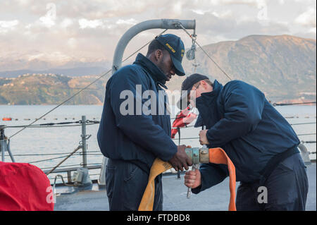 150411-N-XB010-013 MER MÉDITERRANÉE (11 avril 2015) Dommage Controlman Fireman Mark Williams, de Macon, Géorgie, à gauche, et les dommages de 3e classe Controlman James Johnson, de Spartanburg, Caroline du Sud, débrancher les deux tuyaux flexibles fournis pierside plomberie dans la baie de Souda, en Grèce, en préparation pour aller en cours à bord du USS Laboon (DDG 58), le 11 avril 2015. Laboon, une classe Arleigh Burke destroyer lance-missiles, homeported à Norfolk, mène des opérations navales dans la sixième flotte américaine zone d'opérations à l'appui de la sécurité nationale des États-Unis en Europe. (U.S. Photo de la marine en masse Communicat Banque D'Images