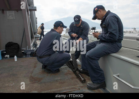 151107-N-TC720-346 La baie de Souda, Grèce (nov. 7, 2015) du canonnier en chef Mate Adam Harlan, de Charlotte, Caroline du Nord, montre deux marins comment prendre une part de calibre 50 à bord des armes à feu USS Donald Cook (DDG 75) Le 7 novembre 2015. Donald Cook, une classe Arleigh Burke destroyer lance-missiles déployés avant, à Rota, Espagne, effectue une patrouille de routine dans le domaine de la flotte des États-Unis 6e des opérations à l'appui des intérêts de sécurité nationale des États-Unis en Europe. (U.S. Photo par marine Spécialiste de la communication de masse Mat 3e classe Murch/libérés) Banque D'Images