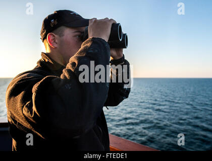 140414-N-KE519-002 MER NOIRE (14 avril 2014) - Matelot Matthew McKeever balaie l'horizon comme l'avant-déployés de la classe Arleigh Burke destroyer lance-missiles USS Donald Cook (DDG 75) approches Constanta, Roumanie pour un service au port. Donald Cook, le premier des quatre destroyers de la classe Arleigh Burke à l'avant-déployé à Rota, en Espagne, est en service dans le cadre d'un service patrouille dans la sixième flotte américaine zone d'opérations dans le cadre de l'Europe du Président Approche adaptative progressive (EPAA) à la défense antimissile balistique en Europe. (U.S. Photo par marine Spécialiste de la communication de masse Seaman Edward Guttierrez Banque D'Images