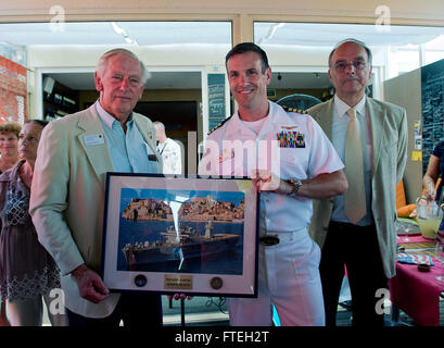 Théoule-sur-Mer, France (13 août 2013) Cornelis "Kees Van Vilet", Président de l'United States Navy League Anglais Riviera-Monaco Conseil, reçoit un don du Capitaine Craig Clapperton, commandant de l'USS Mount Whitney (LCC20) au cours de la Ligue navale Le déjeuner au Café du Parana, 13 août. Cette visite propose de poursuivre les efforts de la flotte des États-Unis 6e pour construire des partenariats maritime mondial avec les nations européennes et d'améliorer la sûreté et la sécurité maritimes. Banque D'Images